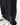 Black wide-leg pants with bold vertical lettering, styled with sneakers