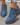 Blue ankle boots on a gray surface