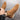 Brown suede ankle boots being worn on a gray surface