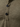 Close-up of a brown shirt with buttons on a textured fabric background