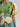 Colorful floral dress with a patchwork design on a plain background