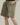 Front view of light gray men's distressed drawstring shorts featuring ripped detailing and relaxed fit