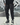 Full outfit shot showcasing black joggers in motion outdoors
