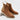 Pair of brown suede Chelsea ankle boots on a white background