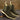 Pair of dark green suede Chelsea boots with beige soles on a textured surface