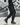 Urban street style outfit featuring black joggers and layered top