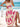 Woman in a beige and pink boho dress on a beach