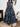 Woman wearing a blue and black patterned dress, front view