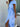 Woman wearing a blue and white striped dress, side view