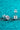 Pair of silver stud earrings with large gemstones on a turquoise glittery background