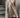A beige coat and skirt standing on steps