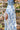 A blue floral skirt with a high slit, front view