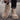 Beige Chelsea boots being worn on a blurred street background