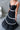 Black dress with white trim worn by a person indoors
