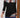 Black long-sleeve top with colorful patterned shoulders and cuffs worn by a person