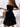 Black off-shoulder dress worn by a person with a white background
