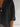 Black oversized shirt worn by a person with a neutral background