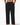 Black pants worn by a person on a white background