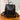Black textured backpack with brown accents on a wooden surface