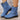 Blue ankle boots with black soles on a wooden floor