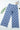 Blue checkered pants on a white background with a leaf and magazine