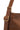 Brown leather handbag with gold buckle on a white background