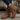 Brown suede boots with zippers on a wooden surface