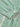 Close-up of a green and white striped garment with a button detail