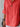 Close-up of a person wearing a coral-colored shirt with a wooden button against a light gray background