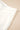 Close-up of a white fabric with pleated details on a beige background