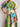 Colorful floral dress with a patchwork design on a plain background