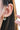 Gold hoop earrings with clear gemstones worn by a person