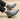 Gray ankle boots worn with black pants on a beige background