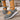 Gray open shoes with white soles 