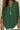 Green blouse worn by a person with a blurred background