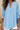 Light blue blouse worn by a person with a neutral background