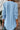 Light blue long-sleeve shirt worn by a person with a neutral background