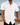 Man wearing a white short-sleeve shirt by the ocean
