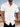 Man wearing a white short-sleeve shirt by the ocean