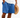 Man wearing blue drawstring shorts with pockets, holding a straw hat on the beach in casual summer outfit