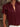 Maroon blouse with ruffled sleeves worn by a person, blurred background