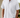 Model wearing white cotton short-sleeve shirt with button collar, hands in pockets
