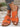 Orange slip-ons, front and side view