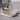 Pair of beige sneakers with white soles on a gray surface