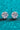 Pair of silver stud earrings with large gemstones on a turquoise glittery background