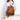 Person holding a brown textured backpack against a plain background