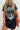 Person wearing a black t-shirt with a guitar graphic and text