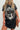 Person wearing a black t-shirt with graphic design and text