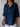 Person wearing a blue shirt with a white background