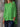Person wearing a bright green top against a stone wall